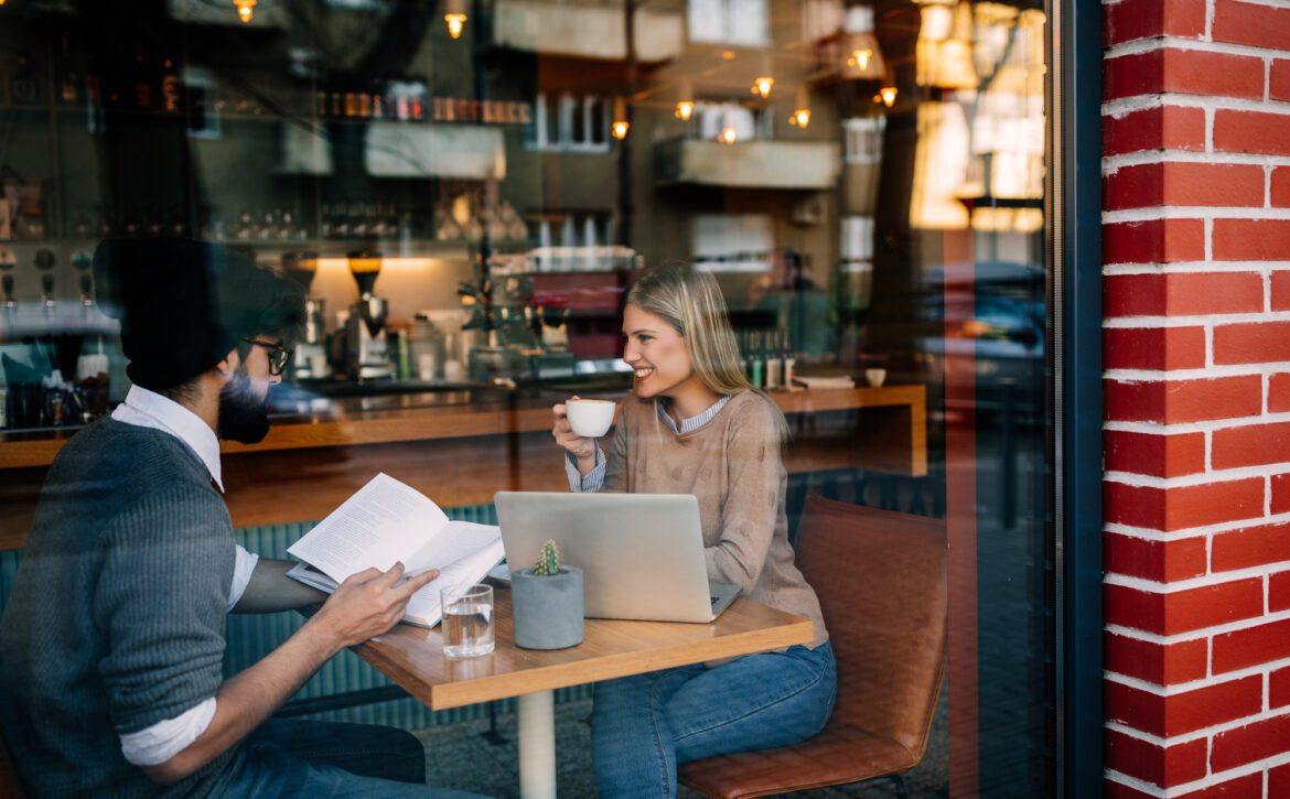 Cropped shot of young man and woman talking in a coffee shop
