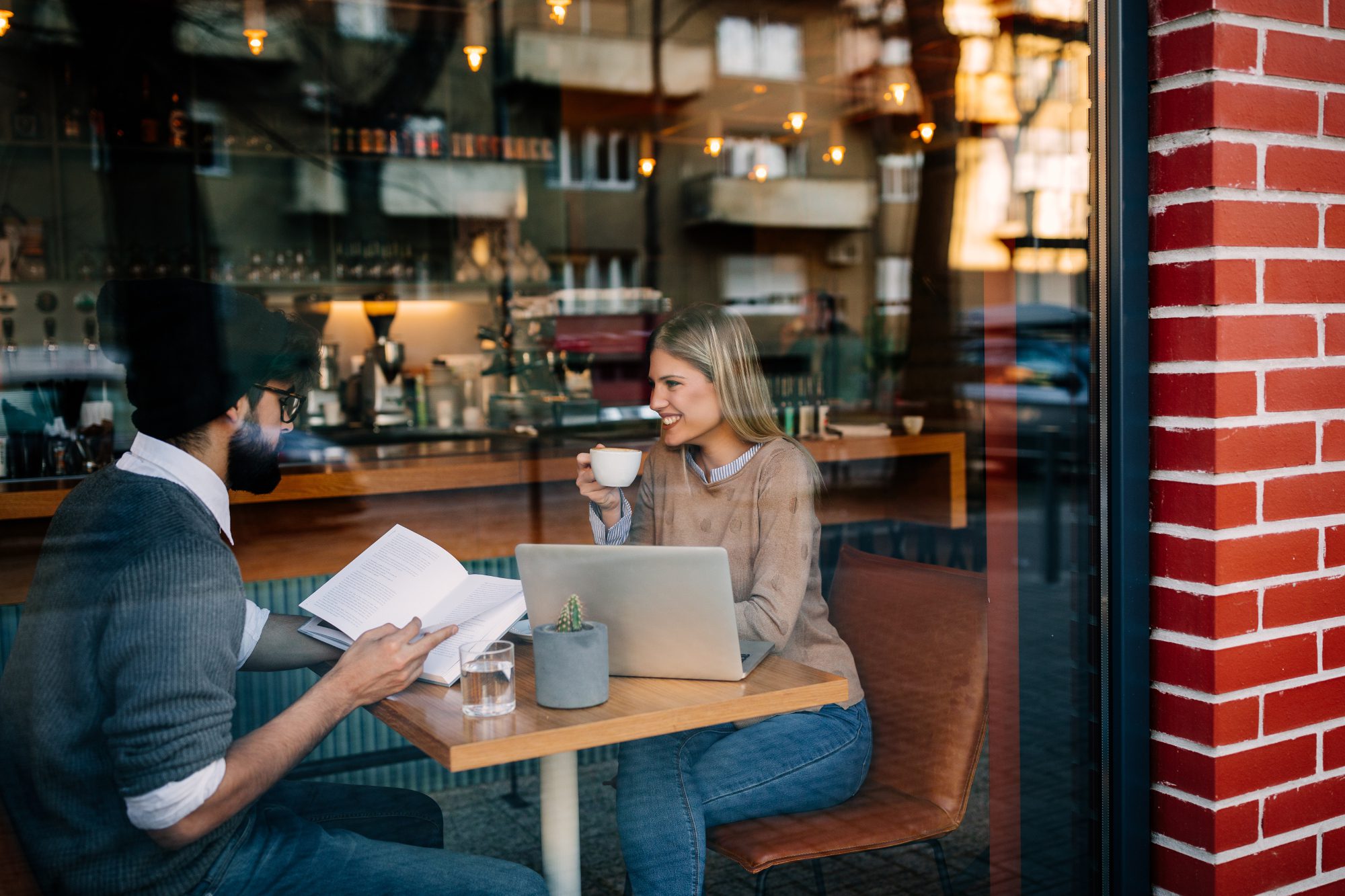 Cropped shot of young man and woman talking in a coffee shop